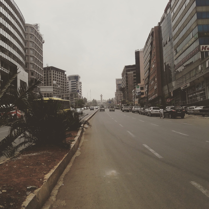 outdoors, road, architecture, skyscraper, 2K, building, direction, city, building exterior, the way forward, nature, car, built structure, street, mode of transportation