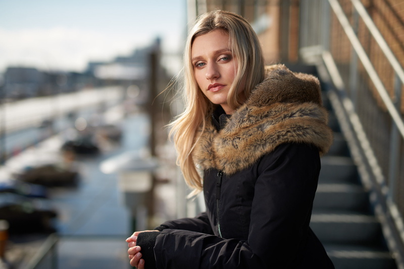 hairstyle, focus on foreground, fashion, Kyle Cong, urban, winter, outdoors, long hair, one person, model, beautiful woman, city, women outdoors, sitting