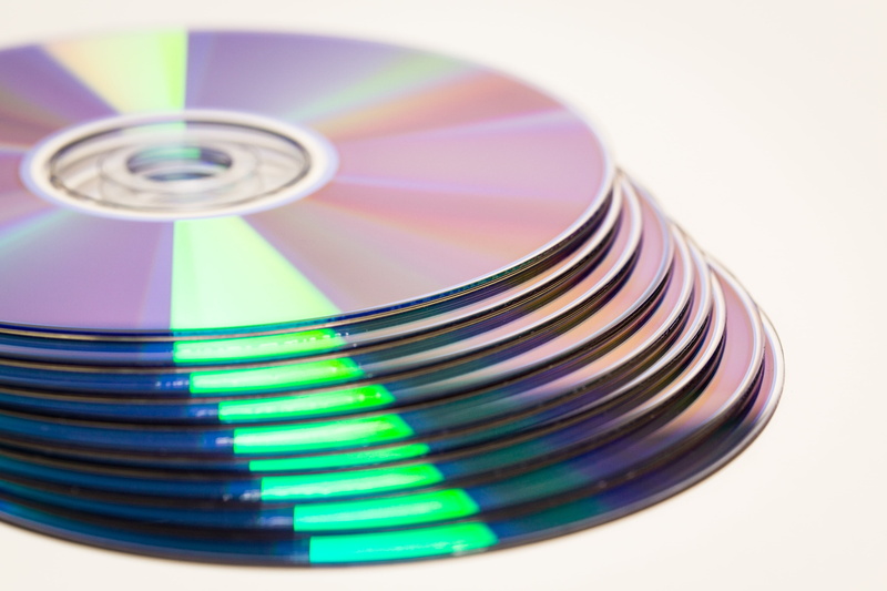 white background, geometric shape, compact disc, circle, data, discs, refraction, colorful, stack, computer, data medium, business, storage medium, light