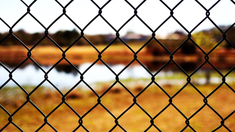 boundary, sunset, security, metal, day, fence, protection, outdoors, crisscross, no people, backgrounds, closeup, pattern, chainlink fence, playing field