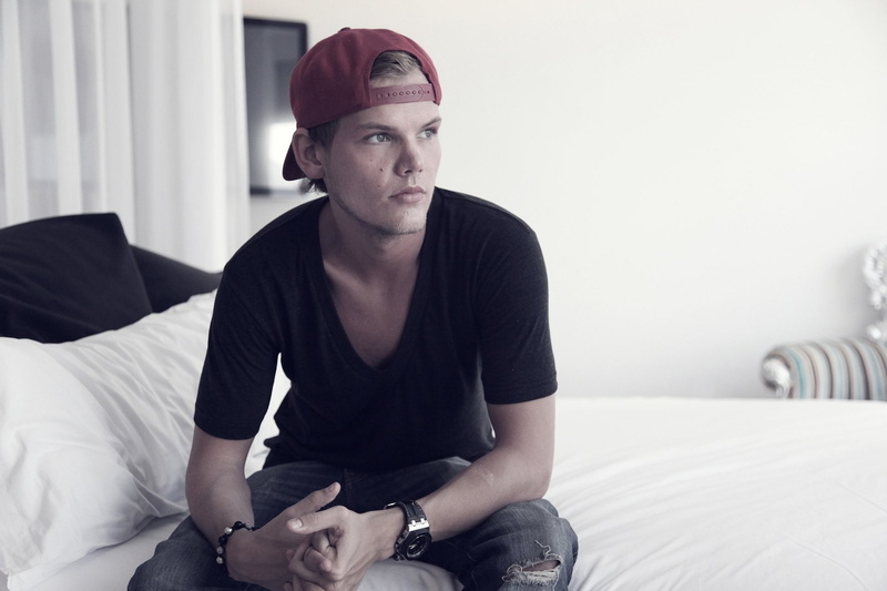casual clothing, young adult, contemplation, portrait, indoors, one person, front view, domestic room, three quarter length, cozy, home interior, Avicii