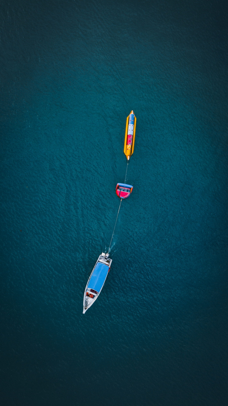 floating on water, transportation, pulling, view, banana, mode of transportation, drone view, adventure, waterfront, turquoise colored, water, outdoors