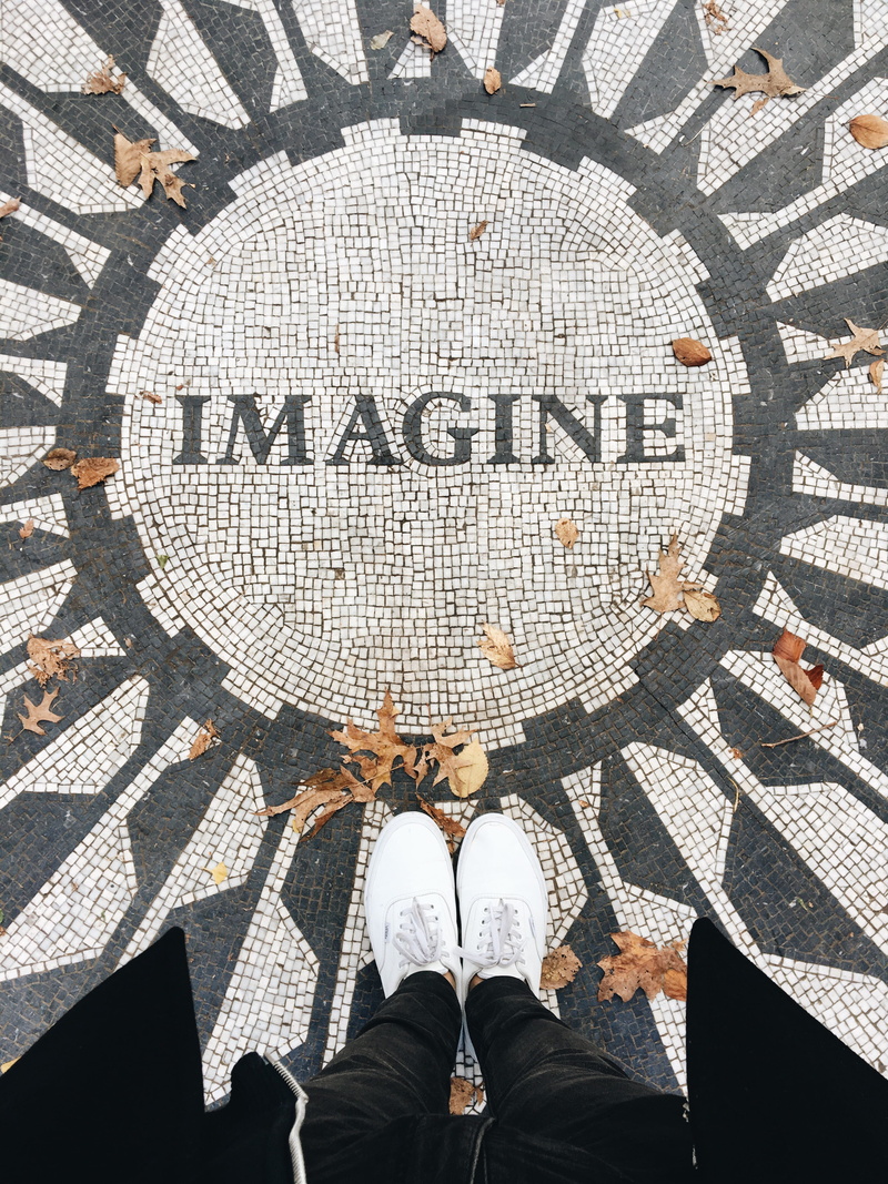 shoe, sign, human limb, text, letters, human foot, united states, directly above, outdoors, central park, real people, personal perspective, john lennon