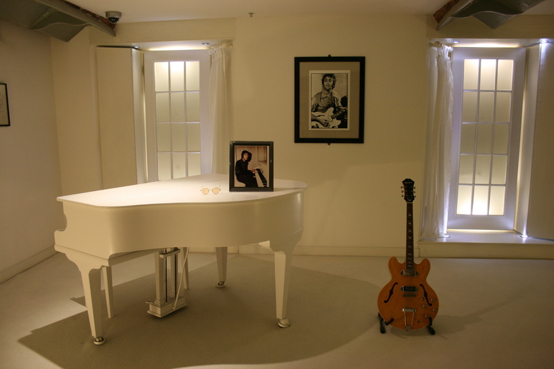 building, table, string instrument, john lennon, grand, lighting equipment, living room, beatles story, home interior, domestic life, music, absence, illuminated