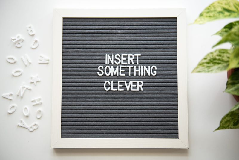text, wall, indoors, sign, decor, white color, architecture, something, single word, built structure, white background, single object, day, communication