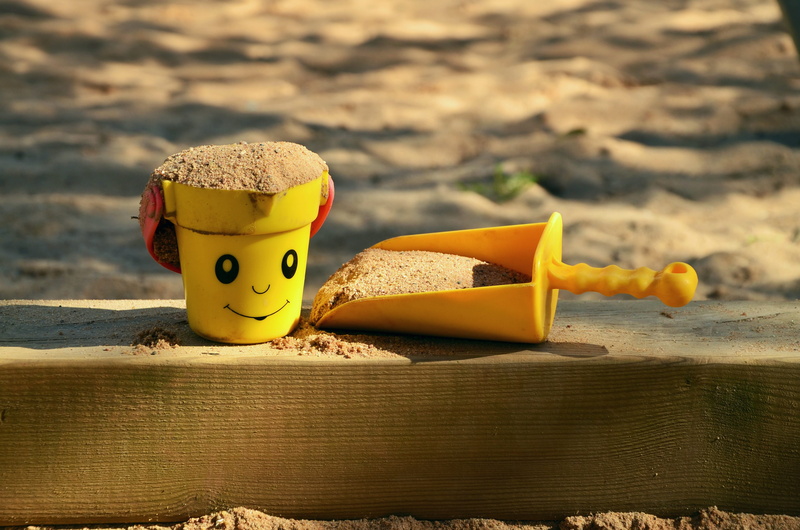 wood - material, sand pit, sunlight, digging, art and craft, smiley, sand, day, toys, bucket, toy, representation, playground, nature, childrens playground