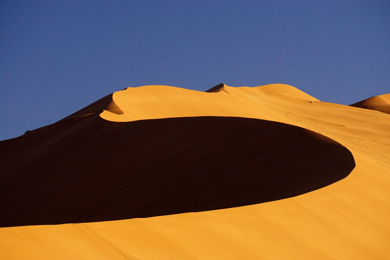 blue sky, beauty in nature, photography, sunlight, africa, low angle view, yellow, copy space, no people, sky, view, dune, shape, travel destinations, day