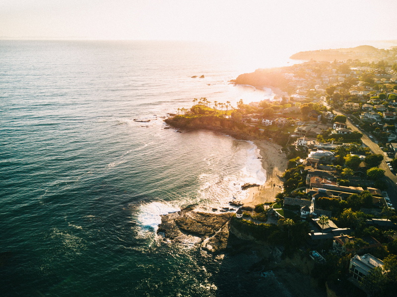 laguna beach, horizon over water, travel destinations, scenics - nature, sunset, shoreline, city, no people, high angle view, water, sky, beach town, sunlight
