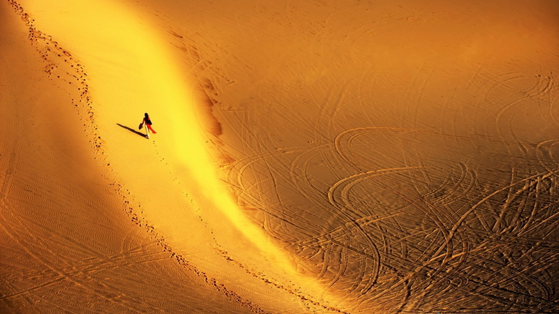 landscape, nature, real people, non-urban scene, environment, tranquility, one person, sand, beauty in nature, arid climate, tire tracks, adventure, climate