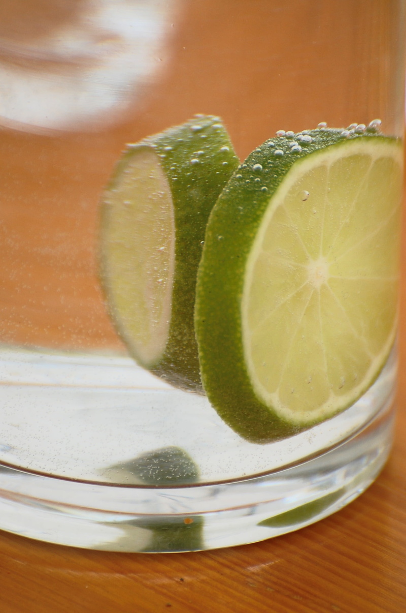 table, lemon soda, household equipment, vesicle, indoors, lemon, food and drink, cocktail, still life, fruit, no people, carbonic acid, lime, drinking glass