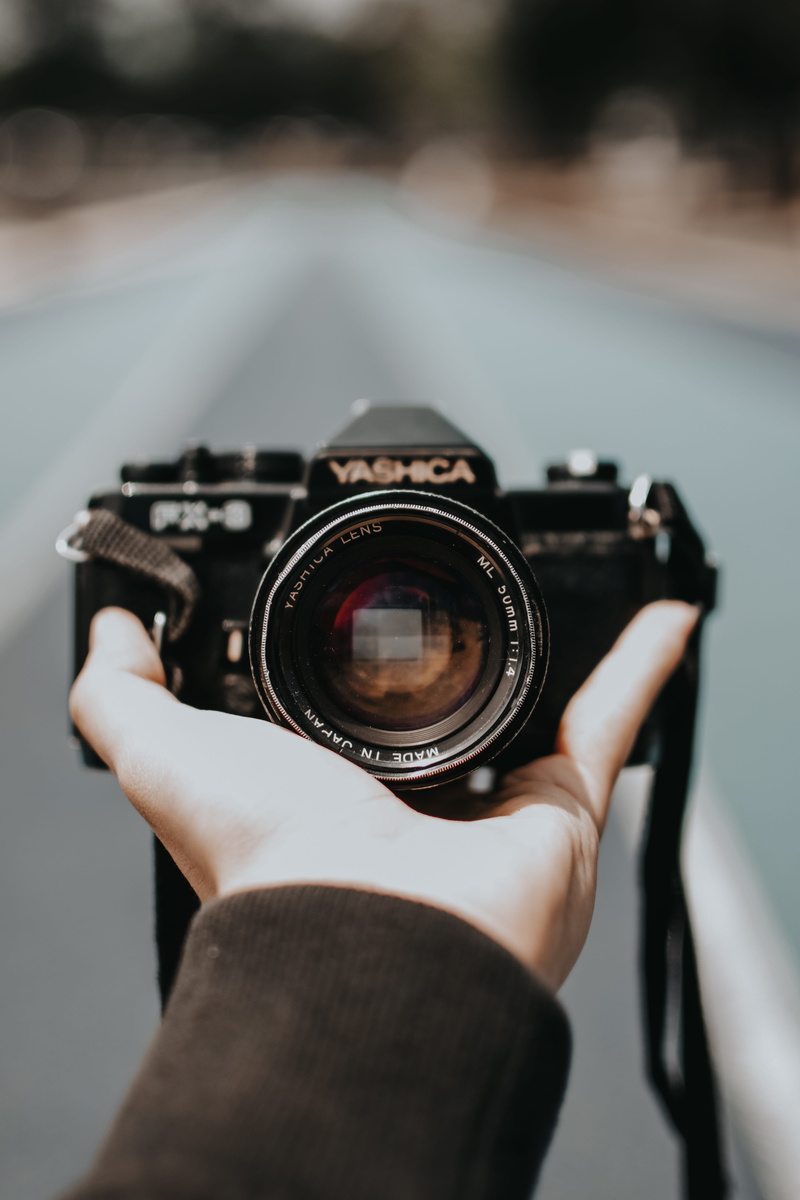human hand, film camera, human body part, old fashioned, close-up, one person, focus on foreground, camera, camera - photographic equipment, yashica, gear