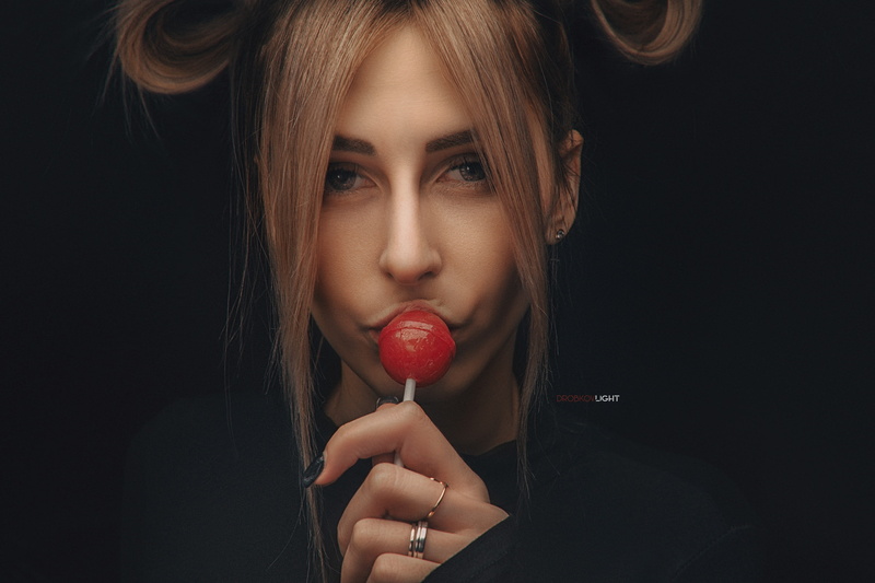brunette, looking at viewer, dark background, portrait, Alexander Drobkov, face, model, lollipop, earring, 2K, dark, rings, black nails, women