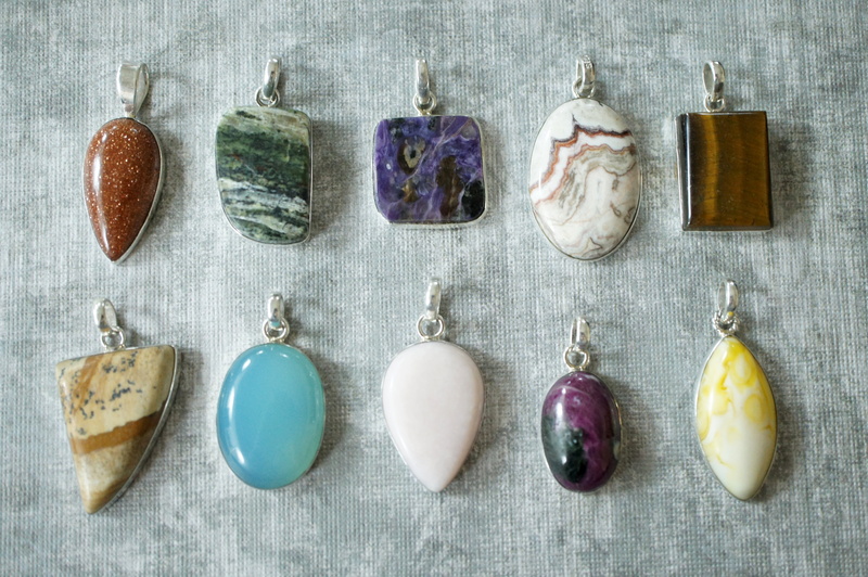 talisman, arrangement, tigers eye, backgrounds, no people, semiprecious, decoration, directly above, assorted, gemstone, amulet, table, stone, color, day