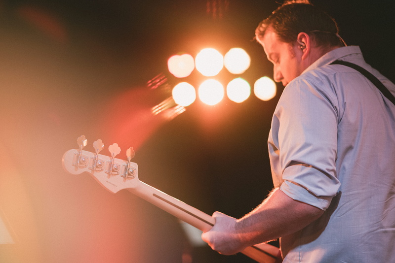 church, young men, lens flare, guitar player, band, one person, indoors, arts culture and entertainment, man, sing, praise, night, waist up, music, technology