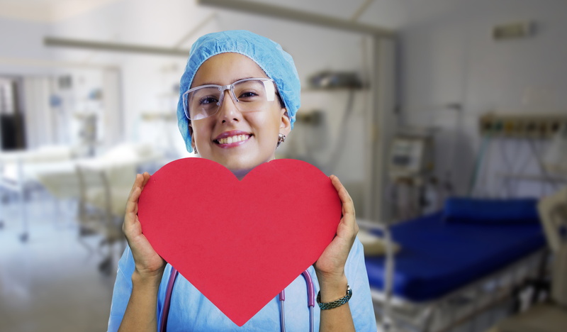 front view, disease, 5K, love, nurse, beautiful woman, heart shape, smiling, hospital, looking at camera, care, one person, happiness, adult, healing