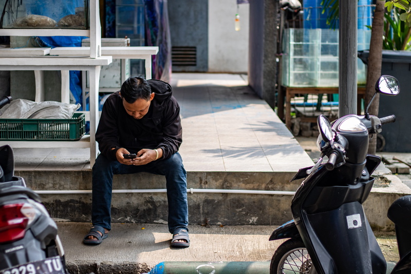 front view, man, men, transportation, motor scooter, scooter, adult, moped, building exterior, casual clothing, gunung sari, young adult, seat, street photography