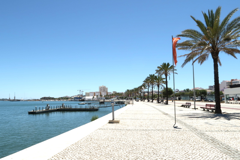 outdoors, portimão, blue, built structure, sunlight, footpath, day, sky, tropical climate, portimao, city, nature, no people, portugal, river, trees, travel