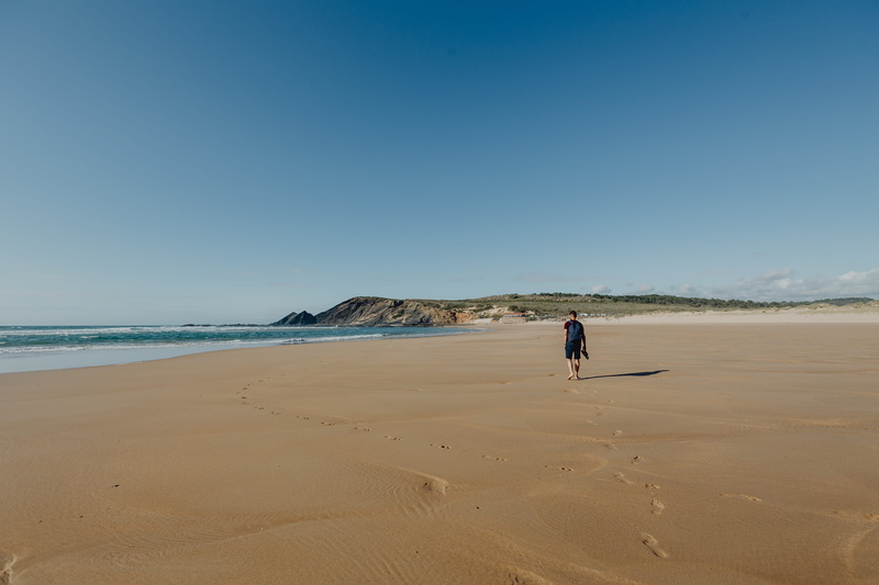 copy space, real people, Europe, sand, walking, full length, day, foot, algarve, clear sky, footprints, land, scenics - nature, nature, sky, ocean, walk