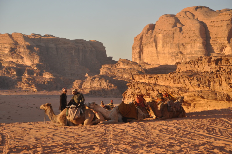 sunlight, real people, three, men, solid, rock - object, sitting, animal themes, arid climate, people, mammal, travel, Wadi Rum, desert, inline, adult
