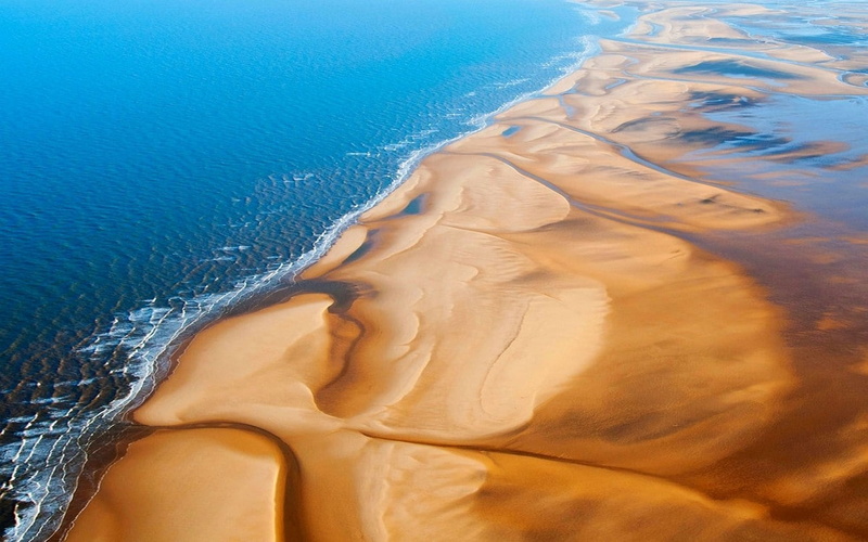 day, body part, nature, outdoors, motion, sand, aerial view, beach, landscape, high angle view, sky, human body part, blue, environment, close-up, water