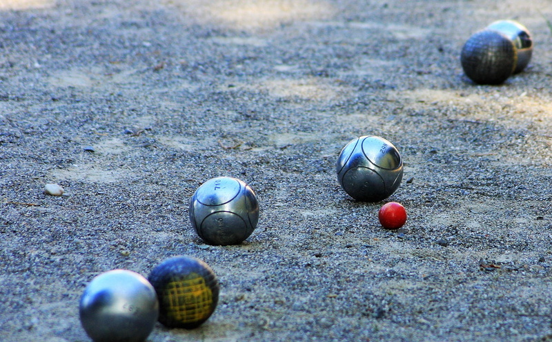 close-up, group of objects, gravel space, no people, boule balls, sports equipment, boule, day, nature, land, floor, outdoors, ball, soccer, silver, balls