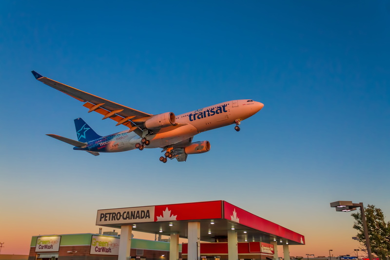 air vehicle, text, airplane, mode of transportation, low angle view, western script, blue, sky, 5K, clear sky, building exterior, communication, business