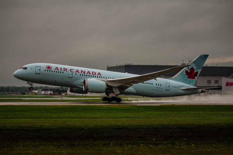 aerospace industry, airliner, tarmac, nature, canada, no people, stationary, transportation, technology, sky, runway, arrival, dark clouds, field, aircraft wing