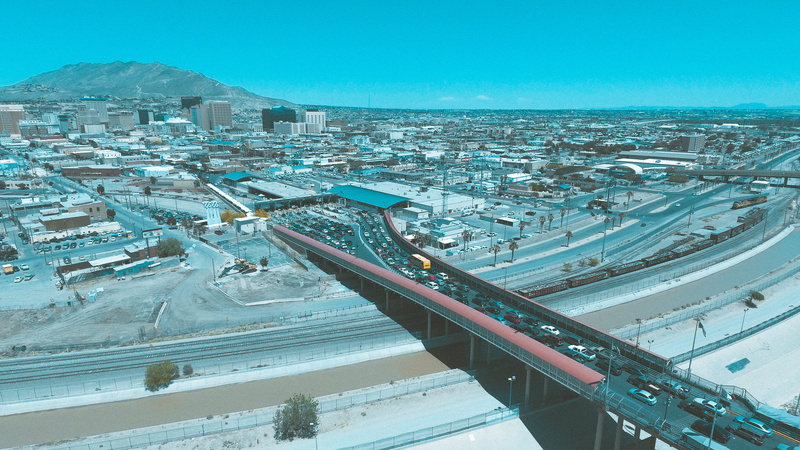 transportation, border, clear sky, water, city, crossing bridge, snow, mexico, bridge, outdoors, cityscape, sky, cold temperature, high angle view, mountains