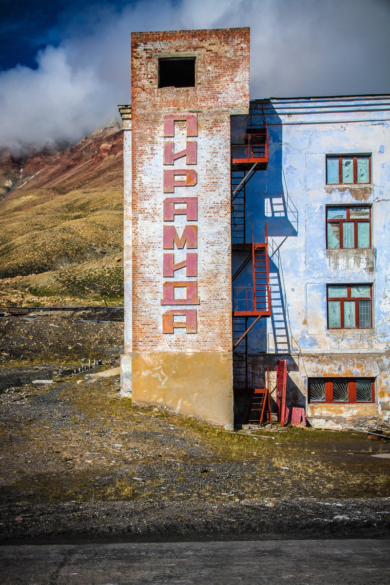 house, no people, communication, sky, factory, svalbard and jan mayen, grass, wall, outdoors, north, building, weathered, nature, cloud - sky, building exterior
