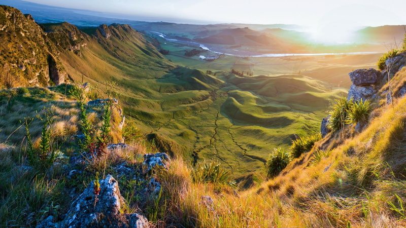 sun, environment, sky, land, tranquil scene, day, tranquility, rock, travel destinations, field, beauty in nature, mountain, grass, shrubland, outdoors