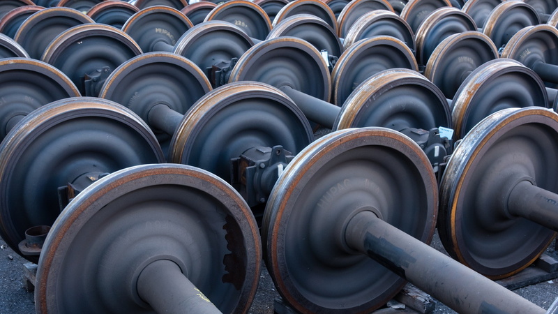 large group of objects, repetition, wheels, side by side, in a row, 1080P, full frame, arrangement, pipeline, backgrounds, rail yard, transportation, no people