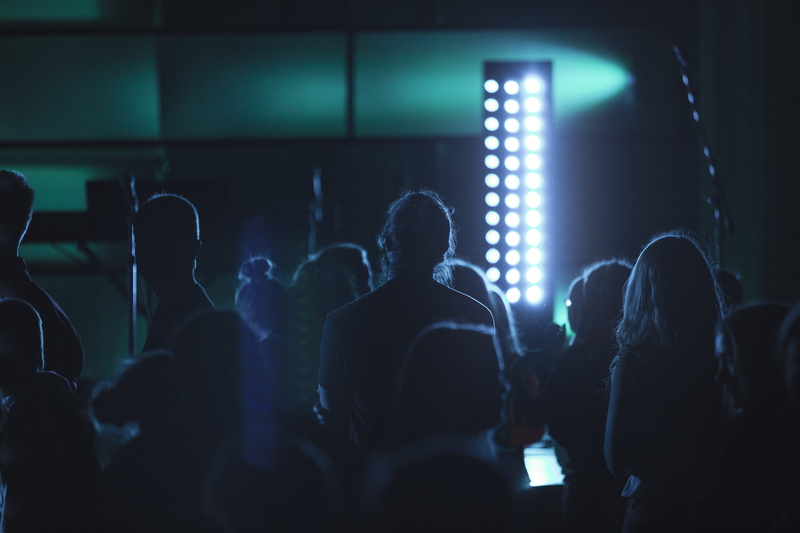 dark, leisure activity, night, lighting equipment, lifestyles, people, adult, concert, crowd, stage Light, entertainment, venue, group Of People, arts culture and entertainment