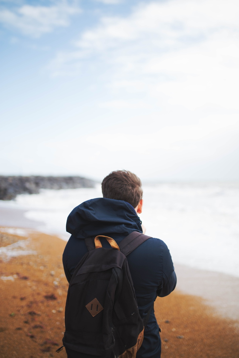 leisure activity, hooded, facing, blue, scenics - nature, waist up, nature, island, portrait, guy, rock, sea, day, daytime, haze, looking at view, white
