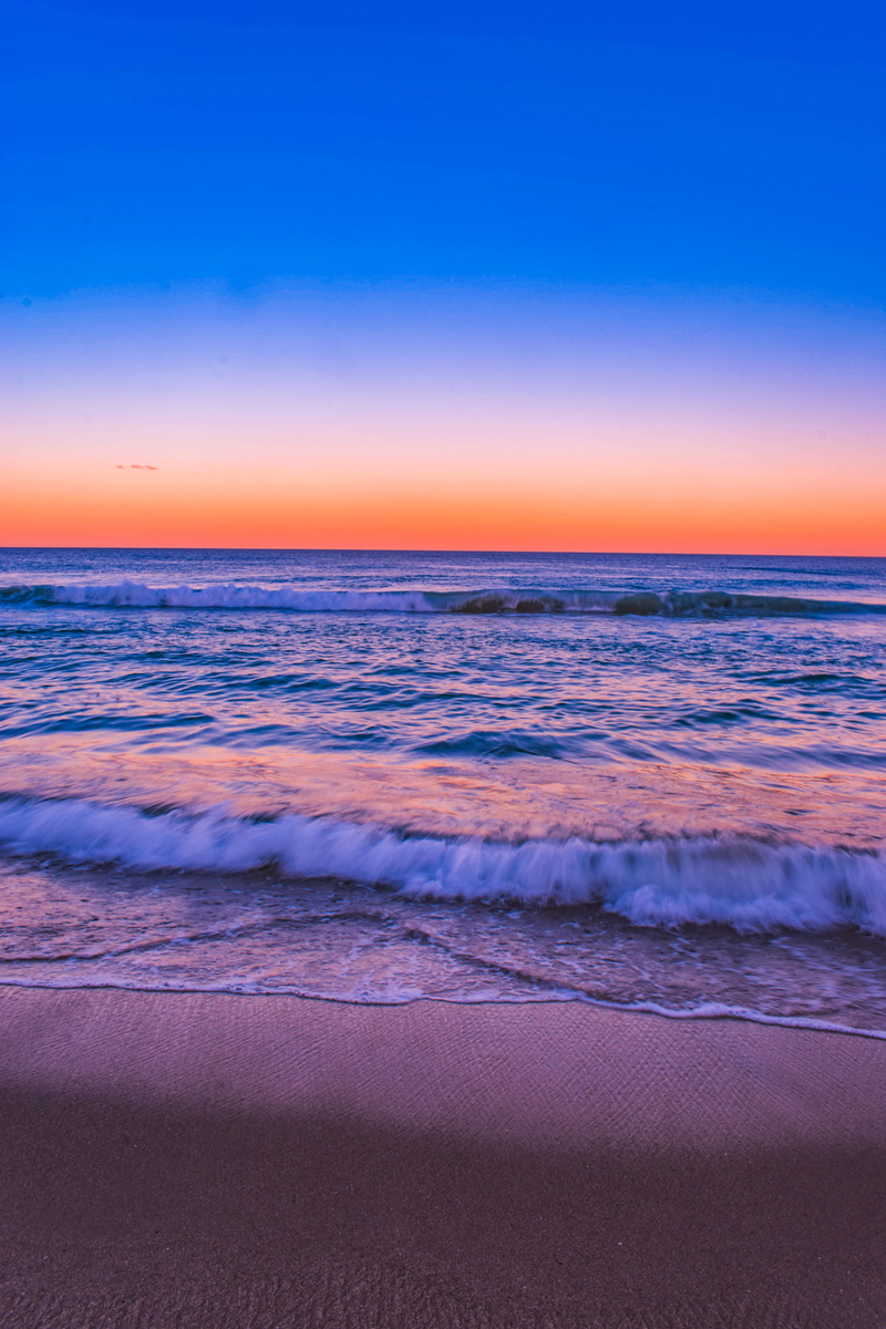 tranquil scene, beautiful, purple, land, wave, sunset, horizon, sport, scenic, sand, sky, seashore, landscape, seascape, seawaves, sea, beach, water, tranquility