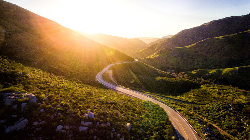 street, light - Natural Phenomenon, plant, valley, tranquility, sunlight, blue, hill, road, serpentine, concrete, non-Urban Scene, mode of transportation