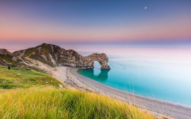 horizon over water, Durdle Door (england), grass, beauty in nature, green, rock formation, no people, natural arch, lawn, near, tranquil scene, sky, nature