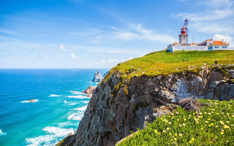 building exterior, cabo, land, water, tower, nature, cliff, no people, lighthouse, cloud - sky, portugal, horizon over water, 4K, scenics - nature, outdoors