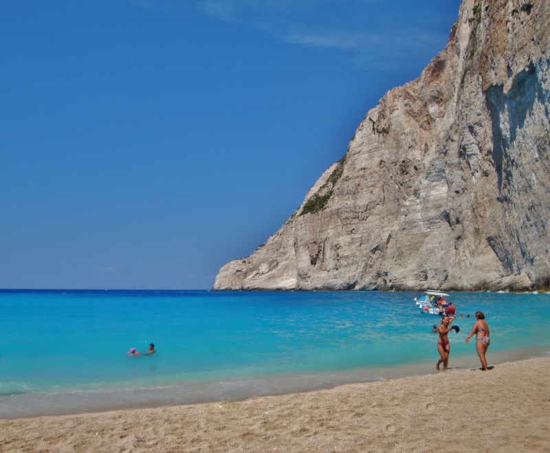 sky, beach, sea, blue, real people, beauty in nature, two people, scenics - nature, island, lifestyles, navagio beach, holiday, horizon over water, summer