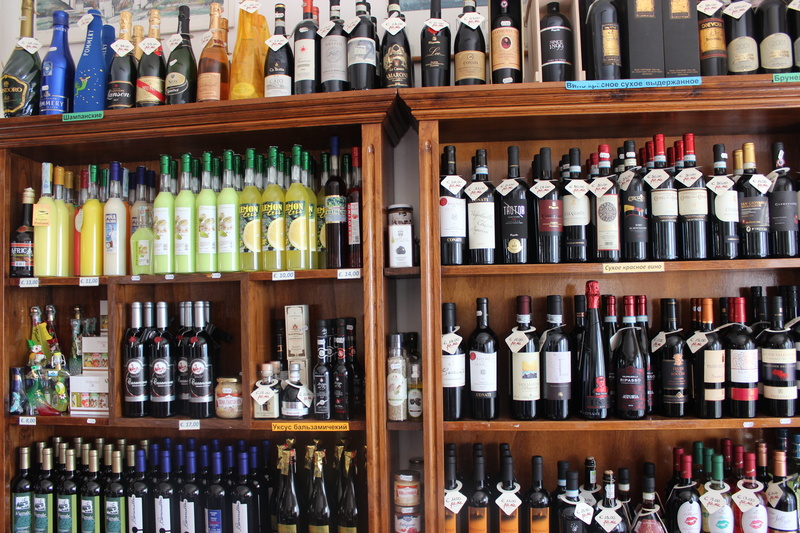 large group of objects, in a row, indoors, bottle, wine bottle, choice, order, sale, refreshment, side by side, collection, san marino, wine, travel, alcohol