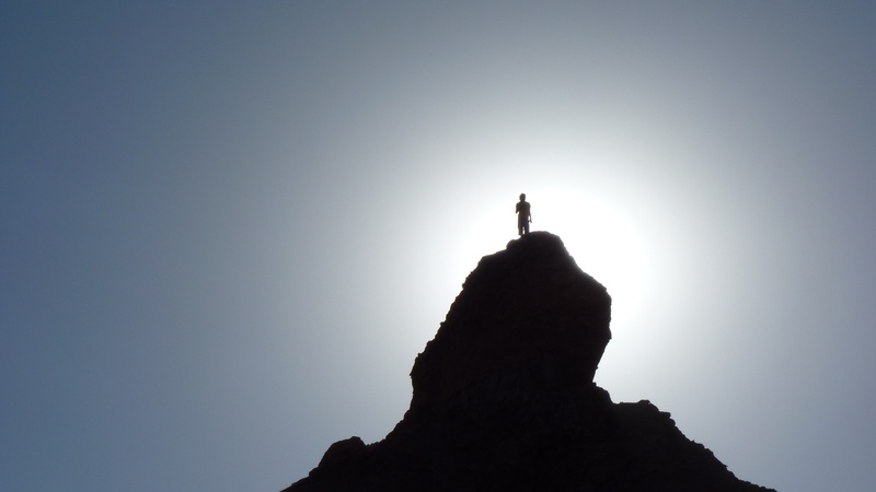solid, peak, mountain, back lit, rock, mountains, adventure, clear sky, climber, one person, scenics - nature, standing, nature, hill, rock - Object, sky