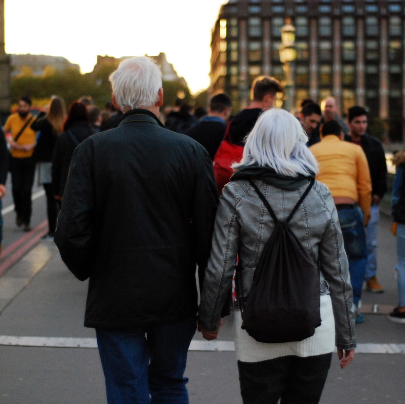 city, royalty  images, jacket, real people, back view, men, walking, black, three quarter length, holding hands, man, incidental people, people, day, adult