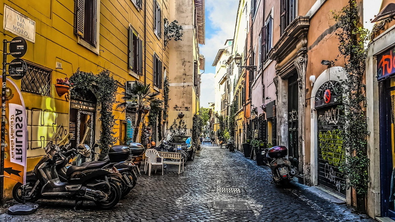 building, diminishing perspective, facade, motorcycle, no people, day, residential district, narrow, direction, neighbourhood, mode of transportation, cobblestone