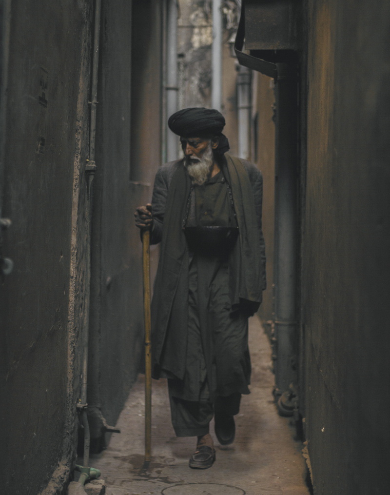 person, one person, coat, street, walking, standing, photo, old, architecture, alley, real people, government, warm clothing, looking, casual clothing