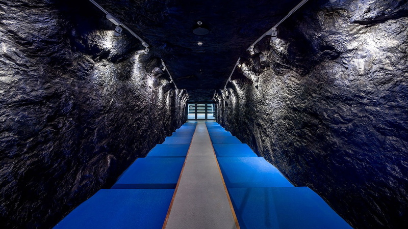day, symmetry, outdoors, water, sunlight, architecture, sky, no people, cave, stairs, built structure, blue, transportation, footpath, the way forward