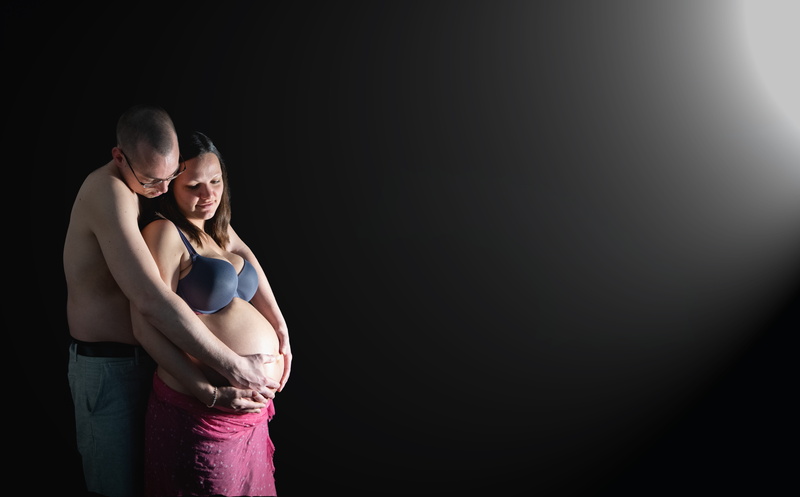 people, black background, two people, bonding, positive emotion, romantic, men, light, adult, baby belly, emotion, birth, indoors, embracing, pregnancy