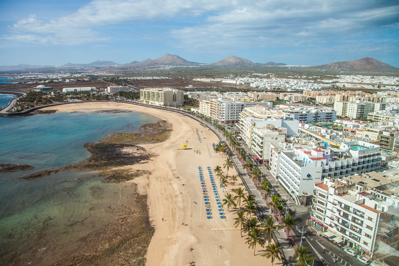 concerns, landscape, volcano, beach, sky, day, island, built structure, sea, coast, building, outdoors, high angle view, capital, nature, canary islands