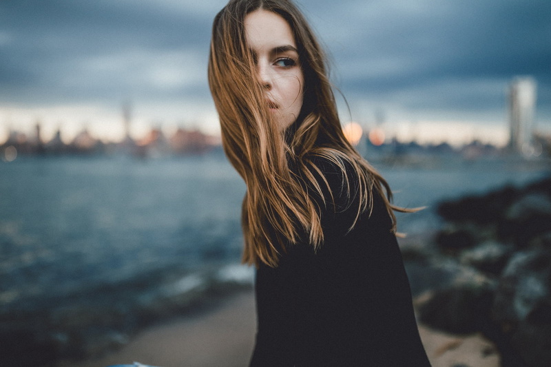 brunette, portrait, women, hair in face, Caitlin Nusche, 720P, young women, sky, one person, hair, young adult, SamAlive, looking, focus on foreground