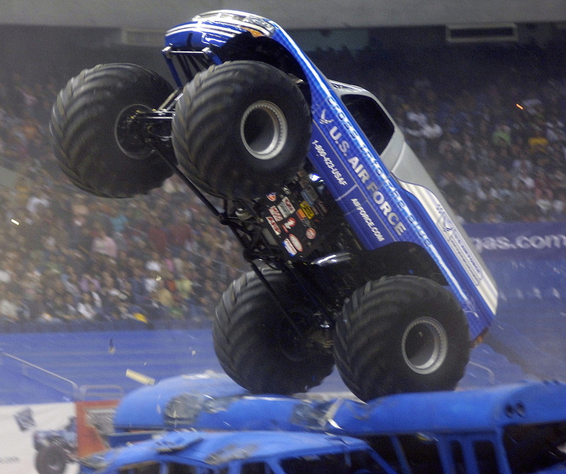 technology, day, monster truck, portrait, motion, travel, stadium arena, obstacles, land vehicle, exhibition, sign, vehicle, speed, blurred motion, engine