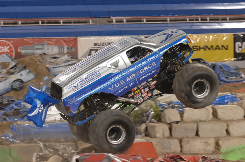 obstacles, text, wheel, vehicle, building exterior, modified, blue, 4K, jam, shopping, stadium arena, stationary, monster truck, architecture, metal, outdoors