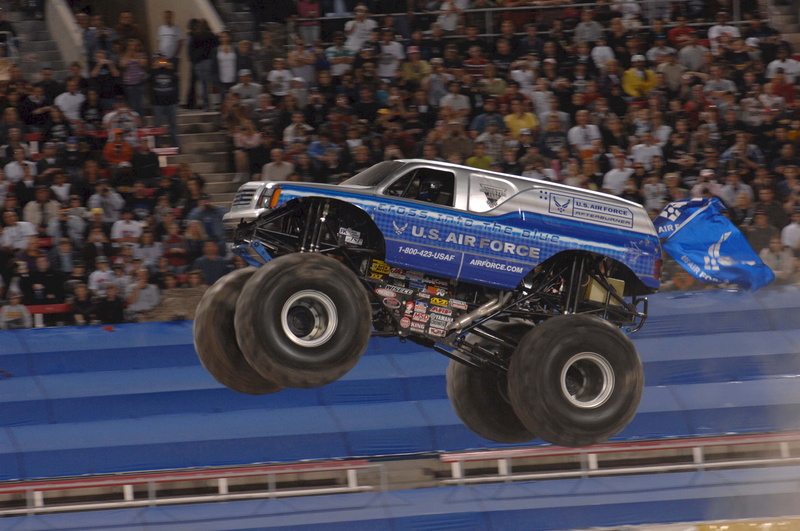 monster truck, sport, sports race, rally, transportation, competition, blue, spectator, motion, government, car, exhibition, mode of transportation, security